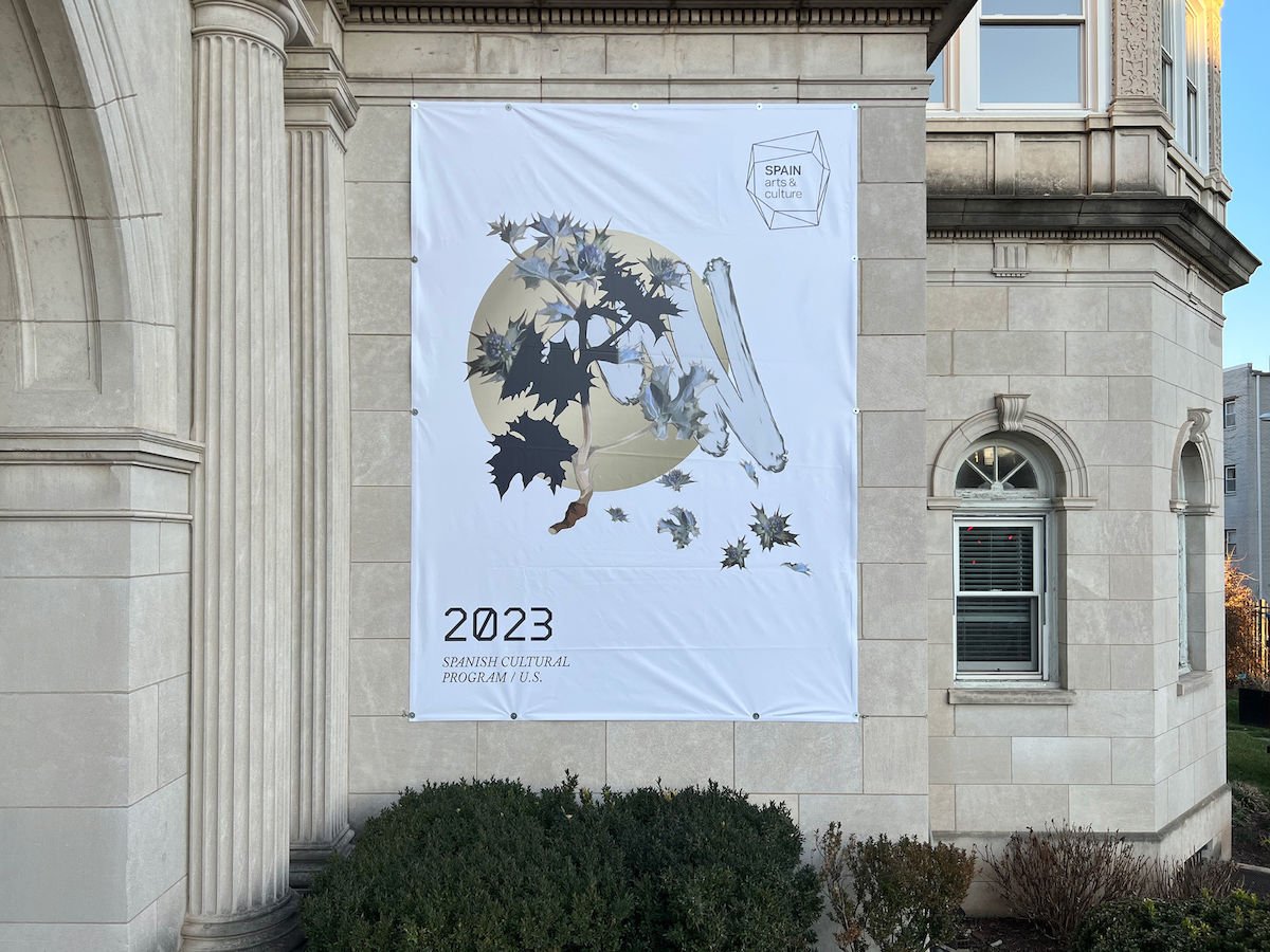 Cover of the cultural program hanging from the façade of the Embassy of Spain